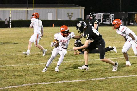 Marion County’s Omarion Smith stiff-arms an incoming defender.