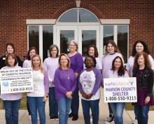 Members of the Marion County Department of Human Resources stand in front of the DHR building displaying their purple shirts on Purple Thursday. Front row from left are Lynn Knight, Jamie Carter, Charlotte Lindsey, Elisha Brewington, Kim Lolley and Darlene Palmer. Back row from left are Dwan Madden, Misty Miller, Suzanne Hester, Marilyn Cook, Melanie Norris, Holly Prescott and Amanda Arnett.