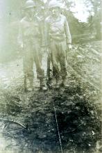 Hasten (left) and Robert Crow are shown after they met in France. Notice the communication wire on the ground.