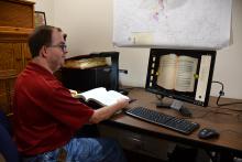 John Boyett of Hamilton B.A.S.E. scans one of the city’s ordinance books with a new scanner able to copy the images without each page being taken out.