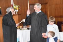 Shown getting sworn in (right) is new 25th District Court Judge Hunter Fikes and his two sons, Townes and Tripp, standing nearby. Shown swearing Fikes in is 25th Circuit Court Judge Daryl Burt.