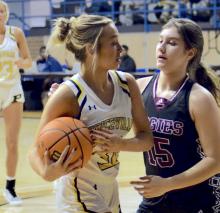 Jordan Parker guards a Priceville player during the regional tournament.